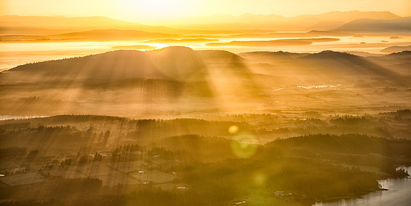 Sunlight Leaking Through Hills and Trees on San Juan Island
